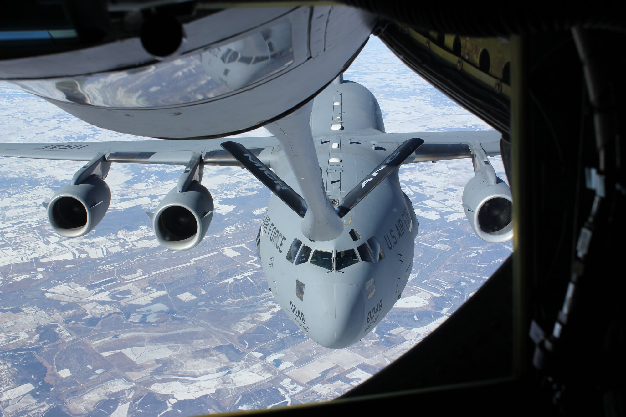 140213-Z-VA676-071 -- A C-17 Globemaster III from the 445th Airlift Wing moves into position behind a KC-135 Stratotanker from the 127th Wing for an in-flight refueling. The 445th is an Air Force Reserve Wing based at Wright-Patterson Air Force Base, Ohio. The 127th is part of the Michigan Air National Guard and operates from Selfridge Air National Guard Base, Mich. The refueling took place over southern Kentucky, Feb. 13, 2014. (U.S. Air National Guard photo by TSgt. Dan Heaton / Released)