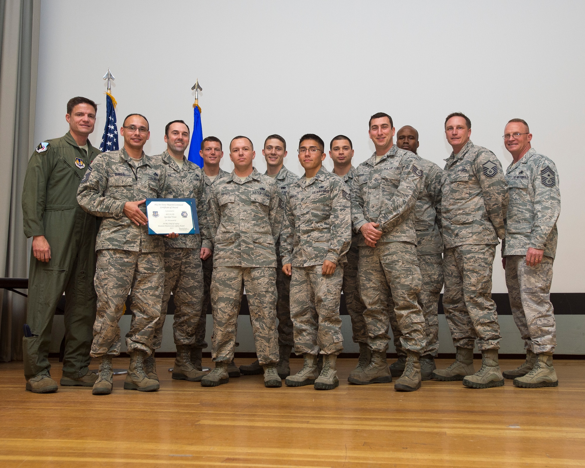 Col. Rodney Todaro (far left), 412th Operations Group commander, poses with members from the 412th Flight Test Squadron - Speckled Trout, after they were presented with the 2013 Air Force Materiel Command Chief of Safety Aviation Maintenance Safety Award during the 4th Quarter Awards at the base theater Feb. 12, 2014. (U.S. Air Force photo by Ethan Wagner)
