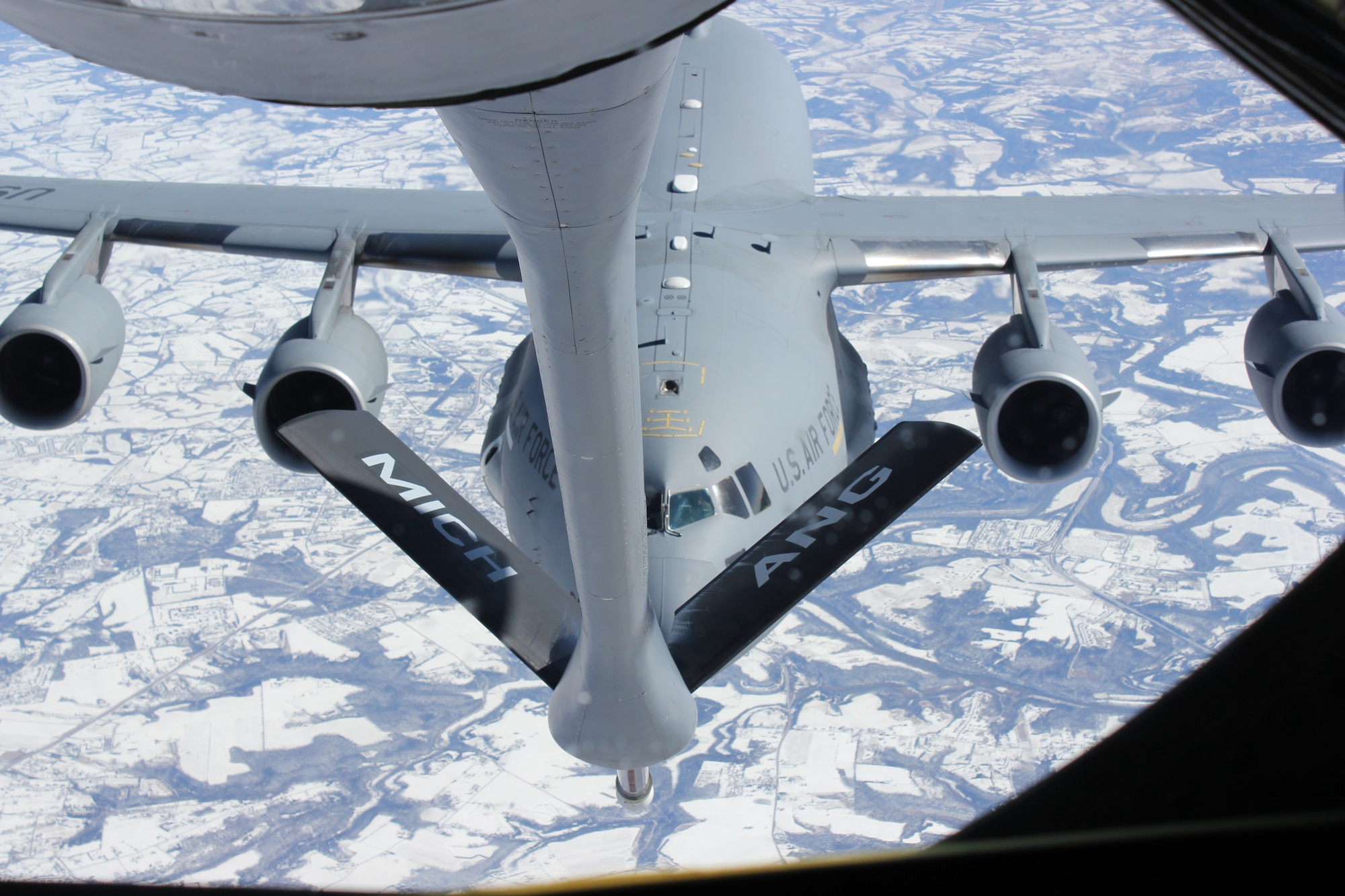 140213-Z-VA676-045 -- A C-17 Globemaster III from the 445th Airlift Wing moves into position behind a KC-135 Stratotanker from the 127th Wing for an in-flight refueling. The 445th is an Air Force Reserve Wing based at Wright-Patterson Air Force Base, Ohio. The 127th is part of the Michigan Air National Guard and operates from Selfridge Air National Guard Base, Mich. The refueling took place over southern Kentucky, Feb. 13, 2014. (U.S. Air National Guard photo by TSgt. Dan Heaton / Released)