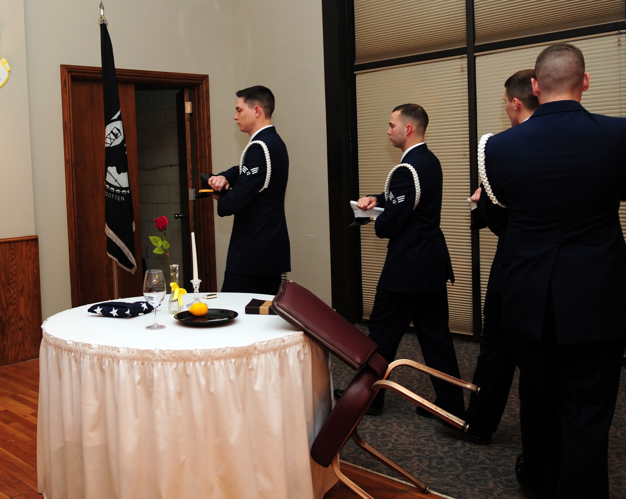 Members of Airman Leadership School Class 14-B set the POW/MIA table during their graduation ceremony Feb. 13, 2014, at Dyess  Air Force Base, Texas. ALS is an approximately five week-long Air Force program designed to develop Airmen into effective front-line supervisors. It is the first professional military education that enlisted Air Force members encounter. ALS focuses on developing leadership abilities as well as effective communication. (U.S. Air Force Photo by Senior Airman Kia Atkins/Released)