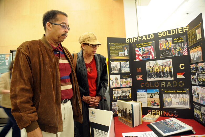 PETERSON AIR FORCE BASE, Colo. – Chris and Margaret Jones, local residents, admire a display highlighting the service and sacrifice of the Buffalo Soldiers during a Black History Month event at the Base Exchange Feb. 14. The event featured members from the local Buffalo Soldiers chapter, the local Tuskegee Airman chapter, and also Navajo Code Talkers, all of whom shared detailed recounts of their service to eager patrons that day. (U.S. Air Force photo/Staff Sgt. Aaron Breeden)