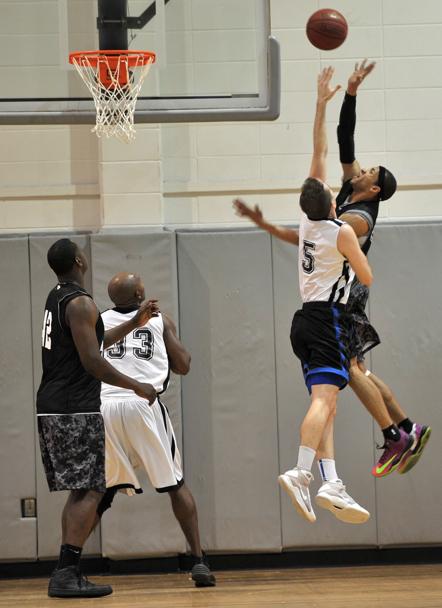 Michael Fitzgerald, Hurlburt Commandos forward, attempts to block Darnell Bing, Gordon Eagles point guard, during the final game of a three-day tournament at the Aderholt Fitness Center on Hurlburt Field, Fla, Feb. 17., 2014. The Commandos won the tournament, defeating the Eagles, 85-68. (U.S. Air Force photo/Senior Airman Kentavist P. Brackin) 