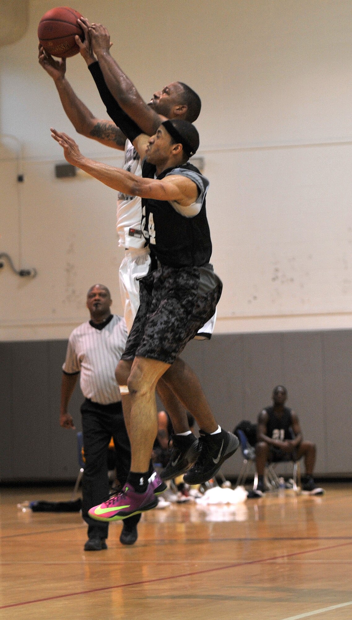 Shedric McElderry, Hurlburt Commandos shooting guard, and Darnell Bing, Gordon Eagles point guard, battle for possession of the ball during a mid-air collision at the Southeast Military Athletic Conference Basketball Tournament at the Aderholt Fitness Center on Hurlburt Field, Fla., Feb. 17, 2014. Seven teams from various bases in the surrounding area participated in the three-day tournament. (U.S. Air Force photo/Senior Airman Kentavist P. Brackin) 