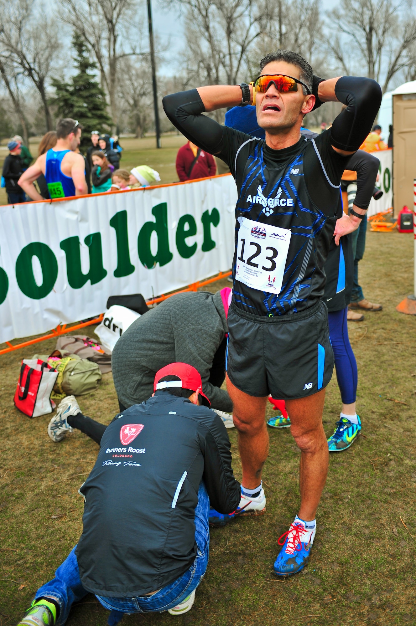 Air Force Reserve Chief Master Sgt. Alex C. Escarcega catches his breath while track officials remove his timing chip seconds after he crossed the finish line February 15, 2014 at Flatirons Golf Course in Boulder, Colo. Escarcega was the sole AF Reservist to compete in the 2014 Armed Forces Cross-Country Championship’s 8 kilometer event. Escarcega finished with a time of 34:24 in the Men’s Master category. Escarcega is assigned to the 310th Operations Group at Schriever Air Force Base, Colo., and serves as the organization’s chief enlisted manager. (U.S. Air Force photo/Tech. Sgt. Nicholas B. Ontiveros