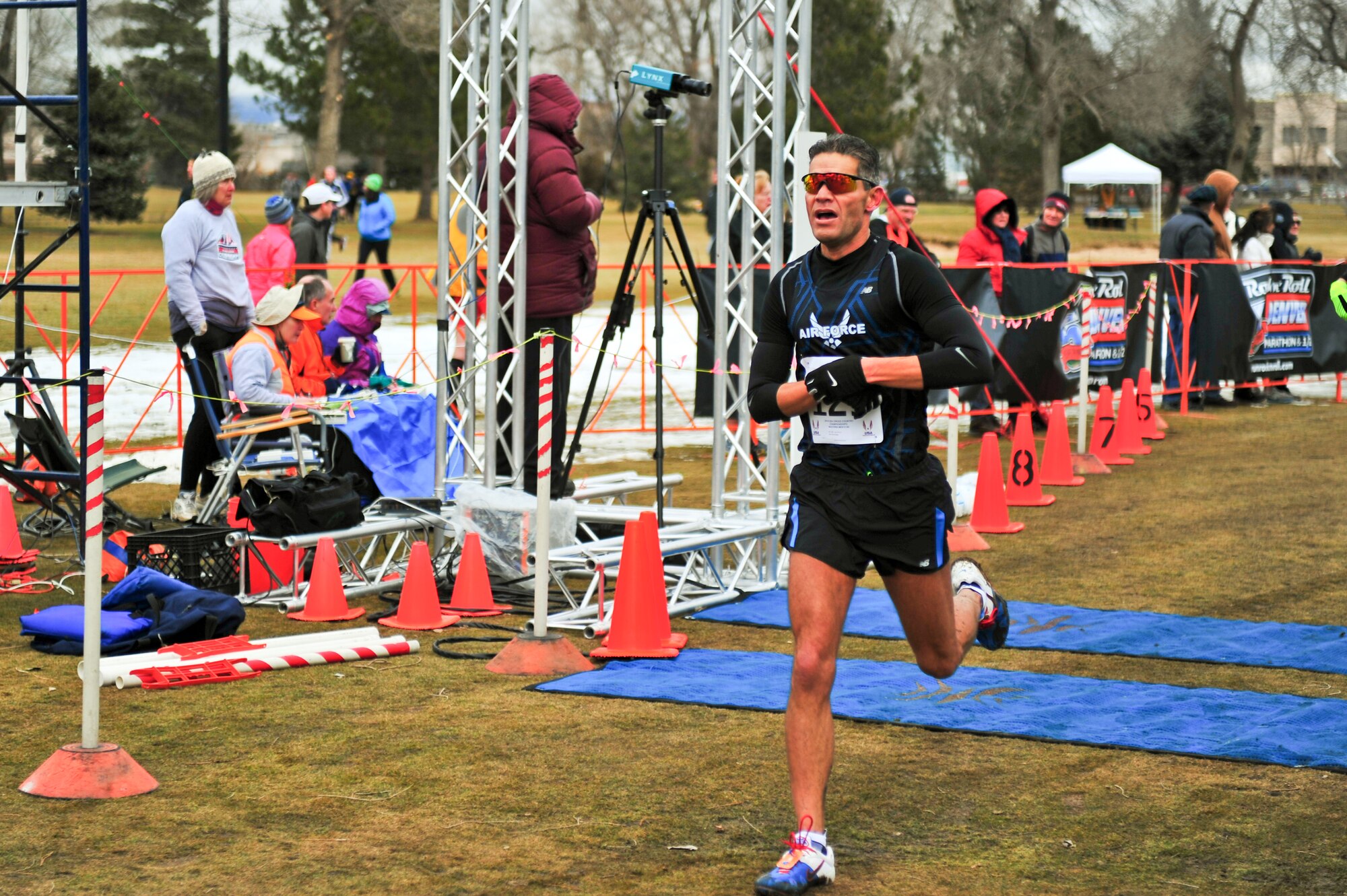 Air Force Reserve Chief Master Sgt. Alex C. Escarcega stops his watch as he crosses the finish line February 15, 2014 at Flatirons Golf Course in Boulder, Colo. Escarcega was the sole AF Reservist to compete in the 2014 Armed Forces Cross-Country Championship’s 8 kilometer event. Escarcega finished with a time of 34:24 in the Men’s Master category. Escarcega is assigned to the 310th Operations Group at Schriever Air Force Base, Colo., and serves as the organization’s chief enlisted manager. (U.S. Air Force photo/Tech. Sgt. Nicholas B. Ontiveros)