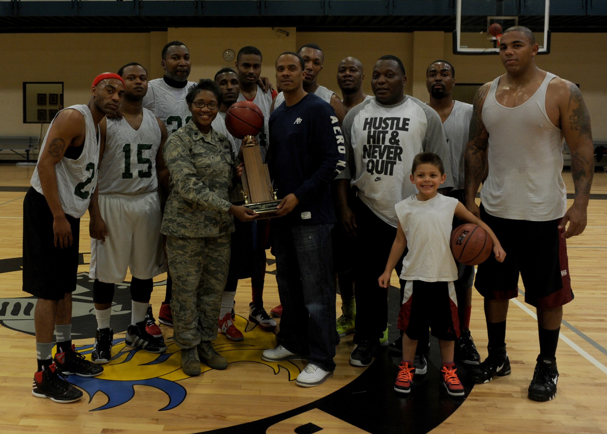 Lt. Col. Angela Cross, 19th Force Support Squadron commander, presents Army National Guardsmen with the intramural basketball championship trophy Feb. 14, 2014, at Little Rock Air Force Base, Ark. The soldiers from Camp Robinson beat the Air Force team 61-44. (U.S. Air Force photo by Airman 1st Class Scott Poe) 