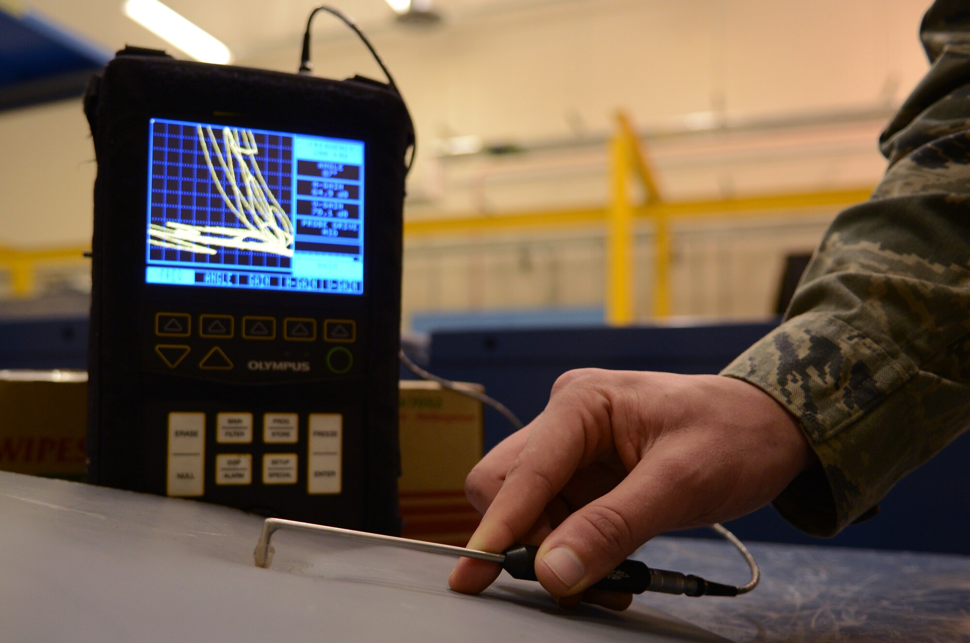 U.S. Air Force Senior Airman Bradley Johnson, 100th Maintenance Squadron non-destructive inspection journeyman from Bakersfield, Calif., uses an eddy current machine to scan a piece of metal for cracks Feb. 11, 2014, on RAF Mildenhall, England. An eddy current pulses a small electronic current through whatever it is in contact with and an interruption in the current indicates a crack or defect. The machine has a display which will change according to whether or not there is a crack or pitting in the object. (U.S. Air Force photo by Airman 1st Class Dillon Johnston/Released)