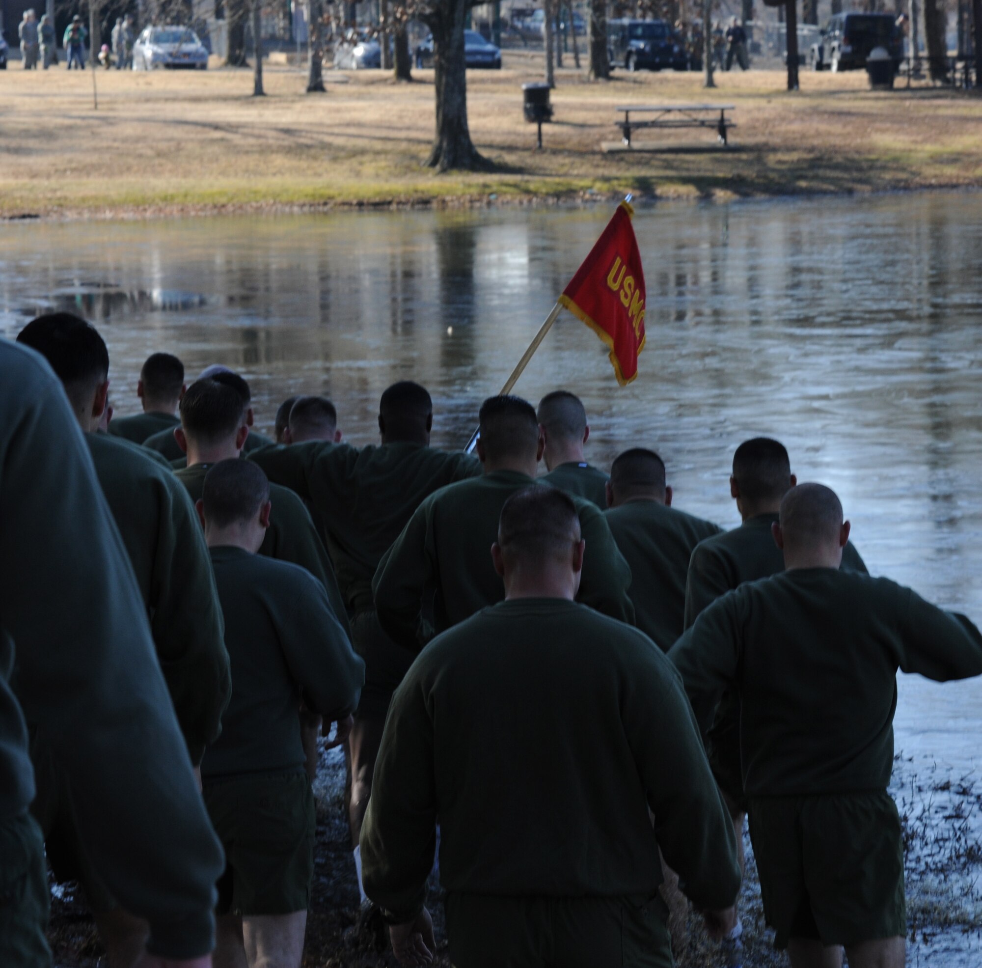 Approximately 40 Marines from the Center for Naval Aviation Technical Training Unit, run in formation into the base lake Feb. 13 at Little Rock Air Force Base, Ark. The dip into the frigid lake was part of the second annual Polar Bear Plunge, an event intended to boost unit camaraderie. (U.S. Air Force photo by Airman 1st Class Harry Brexel)