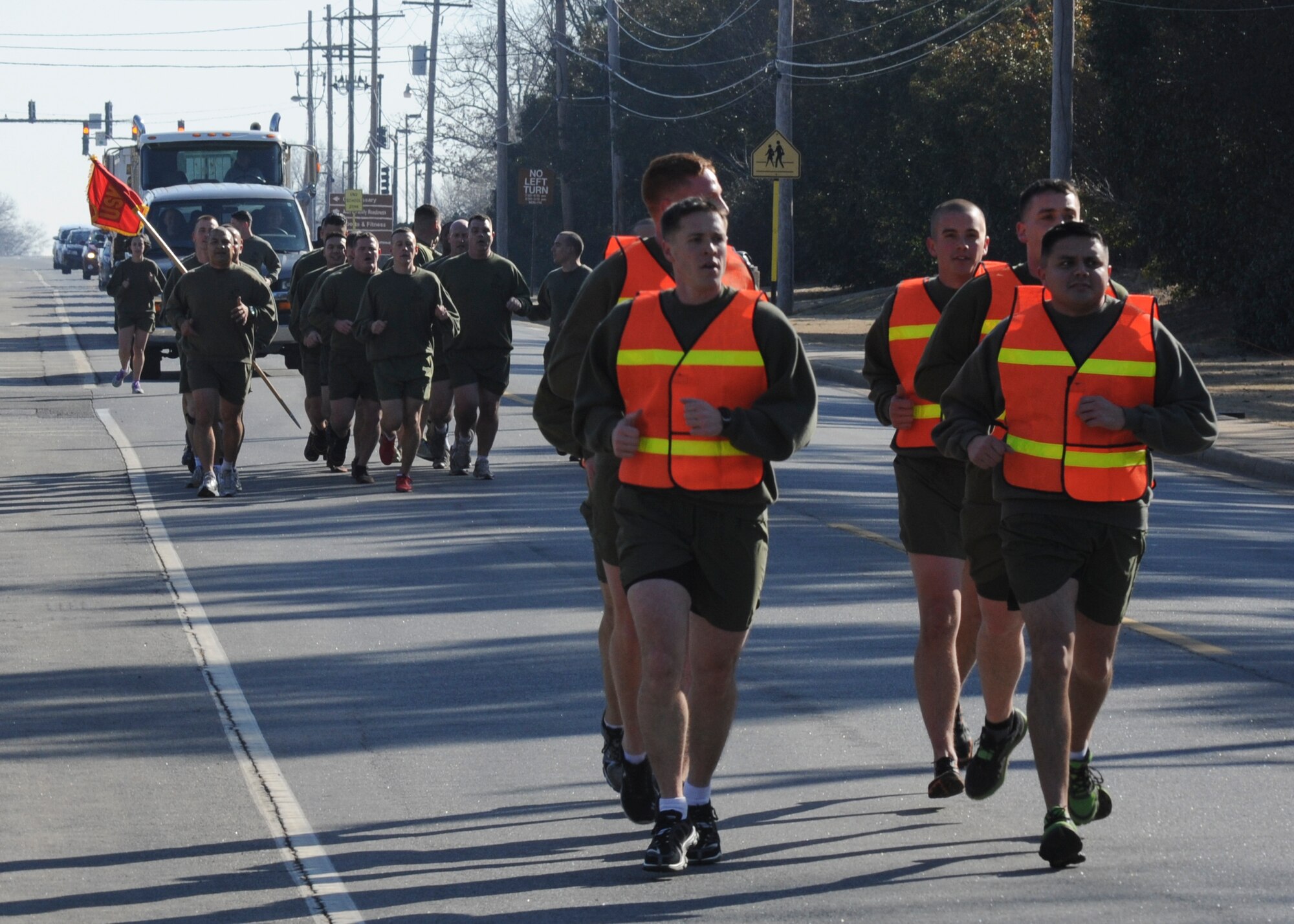 Approximetely 40 Marines from the Center for Naval Aviation Technical Training Unit, run in formation from the Marine barracks to the base lake for the second annual Polar Bear Plunge Feb. 13 at Little Rock Air Force Base, Ark. The Polar Bear Plunge a morale-boosting event that the Marines hold annually. (U.S. Air Force photo by Airman 1st Class Harry Brexel)