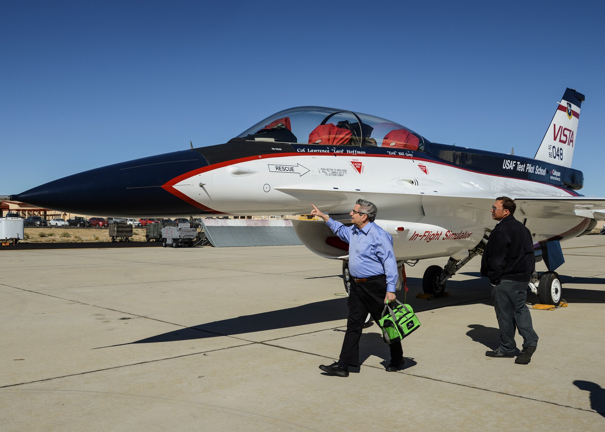 Aviation artist Mike Machat (left) examines the U.S. Air Force Test Pilot School's NF-16D, the one-of-a-kind Variable stability In-flight Simulator Test Aircraft (VISTA) with Calspan operations manager Jason Kirkpatrick (right), looking for any detail that could be lost in his painting. Machat, was recently commissioned to create a 70th anniversary painting for the U.S. Air Force Test Pilot School titled “TPS Generations.” (U.S. Air Force photo by Rebecca Amber)