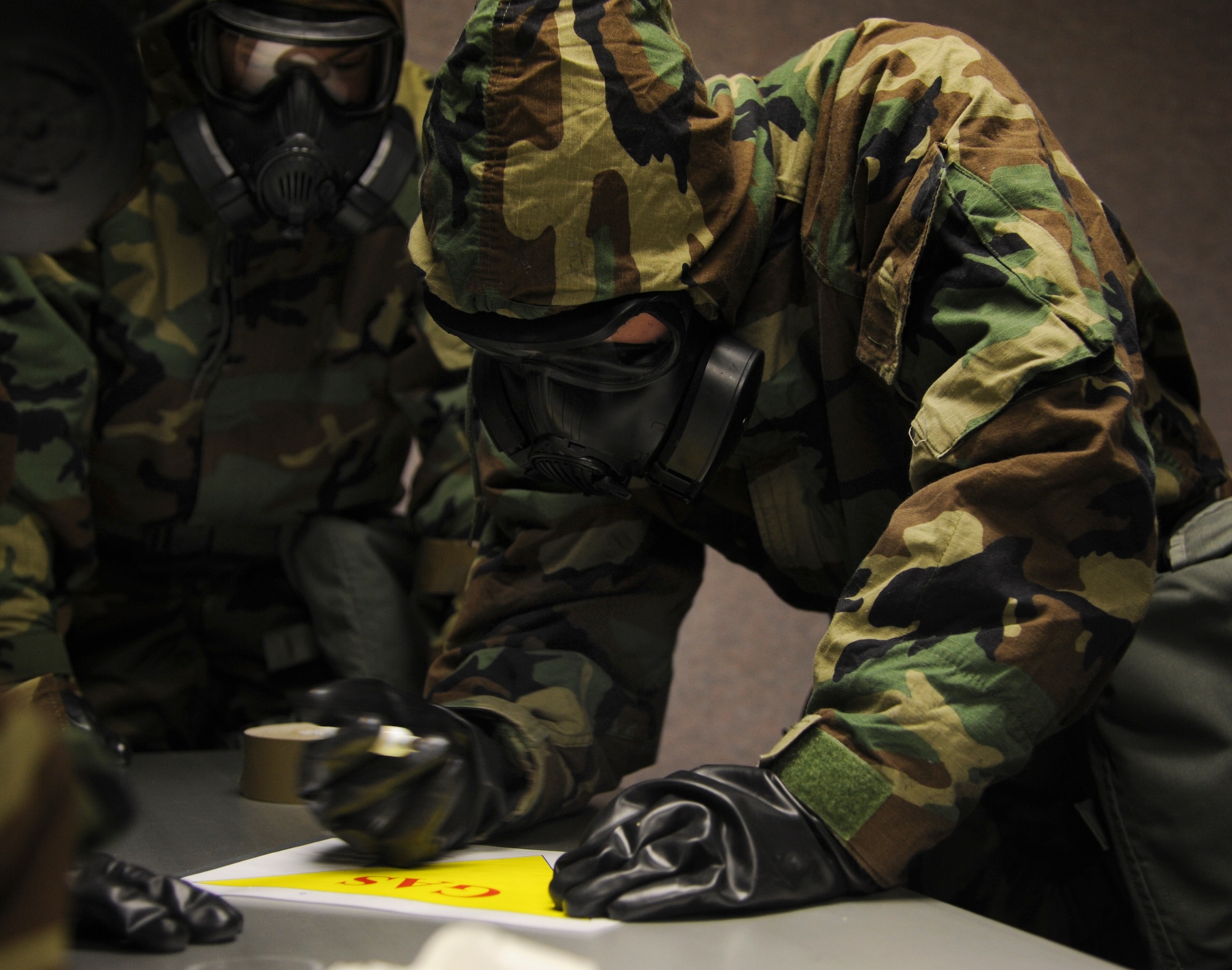 1st Lt. Michael Houston, a 61st Airlift Squadron pilot, marks a simulated contaminant as part of a chemical, biological, radiological and nuclear defense class Feb. 12, 2014, at Little Rock Air Force Base, Ark. Students are taught the use of both M8 and M9 chemical detector paper in the class. (U.S. Air Force photo by Airman 1st Class Harry Brexel)