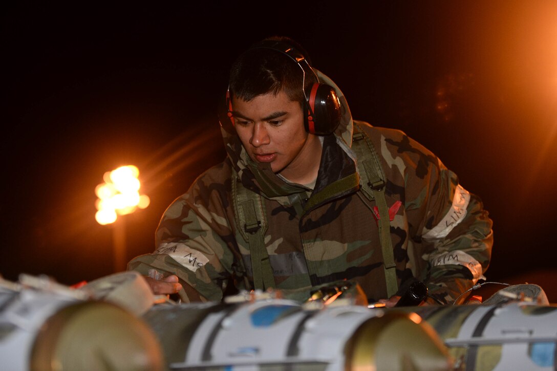 Airman 1st Class Daniel Munoz, 28th Aircraft Maintenance Squadron weapons load crew member, secures an inert guided bomb unit to a trailer during the phase II portion of an operational readiness exercise at Ellsworth Air Force Base, S.D., Feb. 14, 2014. The ORE was designed to educate and expose Airmen to a wide variety of phase II operations, including simulated attacks in a deployed location. (U.S. Air Force photo by Senior Airman Zachary Hada/Released)