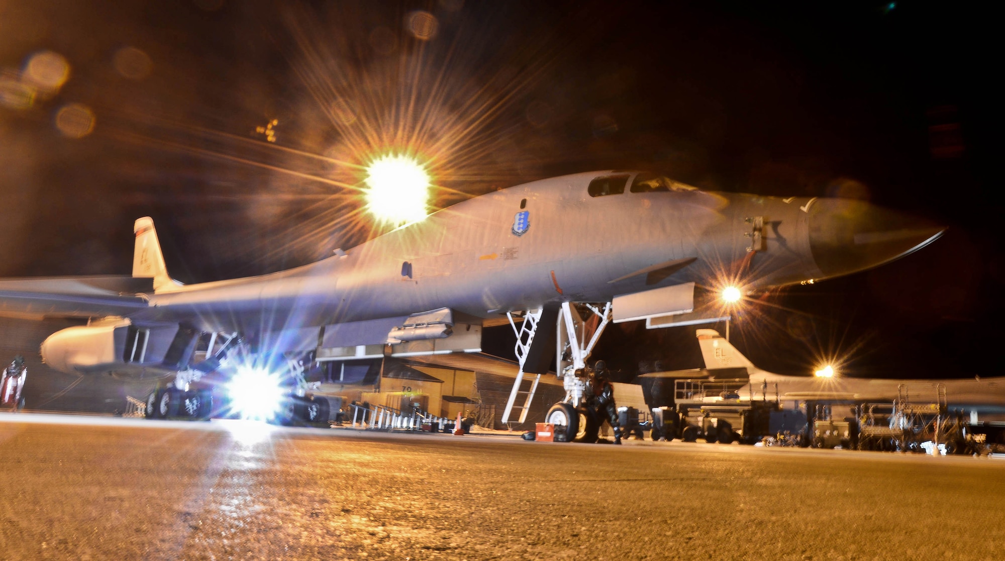 Airmen assigned to the 28th Aircraft Maintenance Squadron prepare to load munitions onto a B-1 bomber during the phase II portion of an operational readiness exercise at Ellsworth Air Force Base, S.D., Feb. 14, 2014. OREs are designed to help Airmen hone their skills in preparation of any real world contingencies they may face. (U.S. Air Force photo by Senior Airman Zachary Hada/Released)