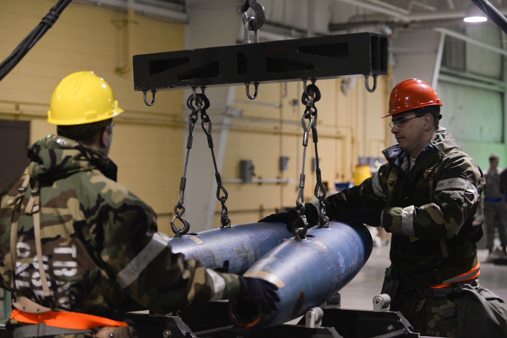 Senior Airman Richard Brooke, and Staff Sgt. Joseph Hale, 28th Munitions Squadron conventional maintenance crew members, assemble inert guided bomb units during the phase II portion of an operational readiness exercise at Ellsworth Air Force Base, S.D., Feb. 13, 2014. The intent of the ORE was to evaluate the 28th Bomb Wing’s ability to meet the wartime and contingency tasks of employing forces, sustaining forces and maintaining the ability to survive and operate in a deployed location. (U.S. Air Force photo by Senior Airman Zachary Hada/Released)