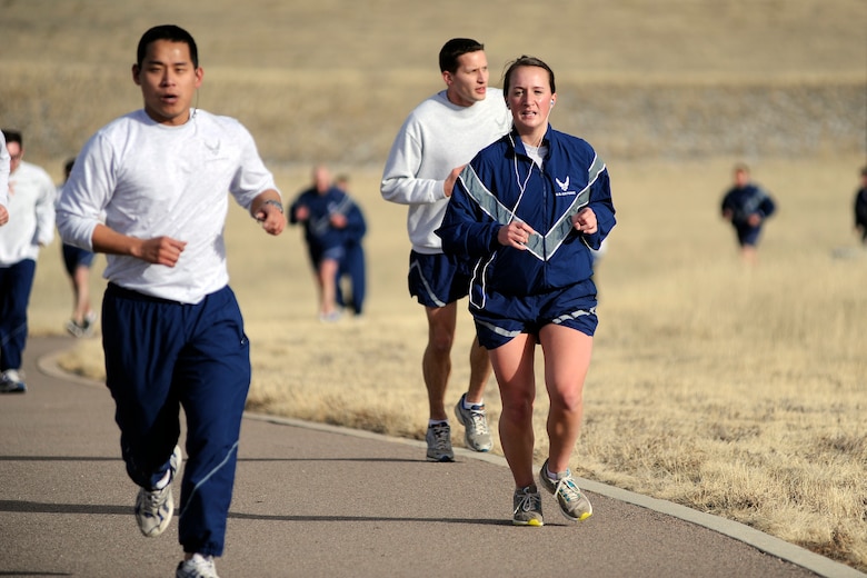 Airman 1st Class Kali Spicer, 50th Force Support Squadron, runs during the 50th Space Wing Warfit Run Feb. 12, 2014, at the Schriever fitness center running track. Spicer is participating in the Lazyman Triathlon, where she has to complete a 2.4-mile swim, 112-mile bicycle ride and a 26.2-mile run within 28 days. (U.S. Air Force photo/Dennis Rogers)