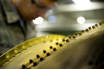 Senior Airman Jacob Pacheco, 5th Maintenance Squadron fabrication flight performs maintenance on a B-52H Stratofortress part at Minot Air Force Base, N.D. Some of the tasks the fabrication flight perform are: welding, engine repair, painting, machine work, searching for cracks and damaged parts, rivet work, creating screws and bolts, and even doing work for the 54th Helicopter Squadron. (U.S. Air Force photo/Senior Airman Brittany Y. Auld)