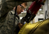 Senior Airman Jacob Pacheco, 5th Maintenance Squadron fabrication flight performs maintenance on a B-52H Stratofortress part at Minot Air Force Base, N.D. The fabrication flight handles all aircraft assigned to Minot AFB and schedules routine maintenance for each one. With Boeing no longer making many parts for the aging aircraft, the fabrication flight improvises and creates hand crafted solutions. (U.S. Air Force photo/Senior Airman Brittany Y. Auld)