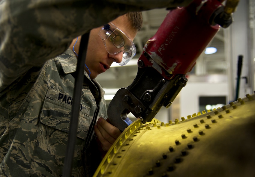 Senior Airman Jacob Pacheco, 5th Maintenance Squadron fabrication flight performs maintenance on a B-52H Stratofortress part at Minot Air Force Base, N.D. The fabrication flight handles all aircraft assigned to Minot AFB and schedules routine maintenance for each one. With Boeing no longer making many parts for the aging aircraft, the fabrication flight improvises and creates hand crafted solutions. (U.S. Air Force photo/Senior Airman Brittany Y. Auld)