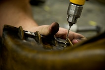 Airmen of the 5th Maintenance Squadron fabrication flight handle all aircraft assigned to Minot Air Force Base and schedules routine maintenance for each one. With Boeing no longer making many parts for the aging aircraft, the fabrication flight improvises and creates hand crafted solutions. (U.S. Air Force photo/Senior Airman Brittany Y. Auld)