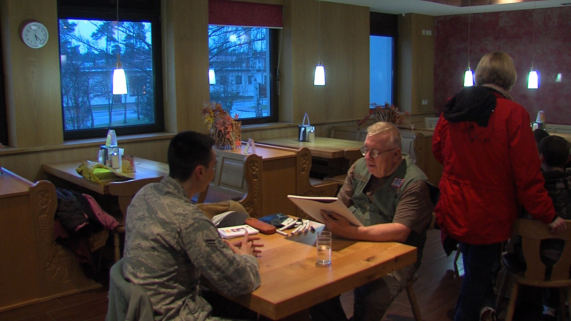 A cartoonist from the National Cartoonist Society sketches an Airman during a United Services Organization event Feb. 10, 2014, Ramstein Air Base, Germany. The National Cartoonist Society is an association that has been drawing sketches and raising morale in the military since World War II. (Courtesy photo)