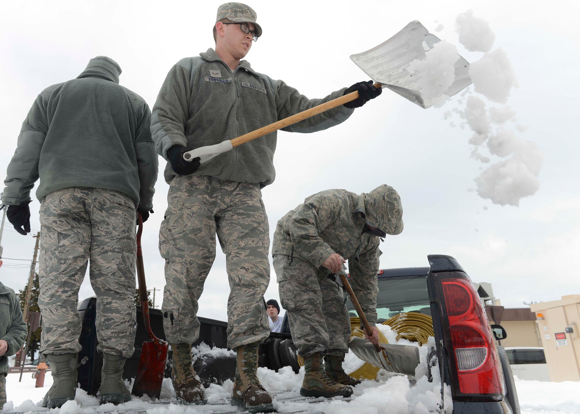 A group of Airmen shovel snow out of a truck after the record-breaking snowstorm at Yokota Air Base, Japan, Feb. 15, 2014.  Yokota thus far received more than 35 inches of snow in the month of February.  (U.S. Air Force photo by Airman 1st Class Soo C. Kim / released)
