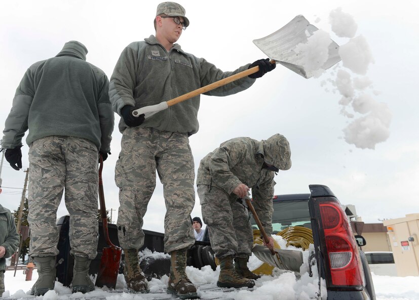 A group of Airmen shovel snow out of a truck after the record-breaking snowstorm at Yokota Air Base, Japan, Feb. 15, 2014.  Yokota thus far received more than 35 inches of snow in the month of February.  (U.S. Air Force photo by Airman 1st Class Soo C. Kim / released)
