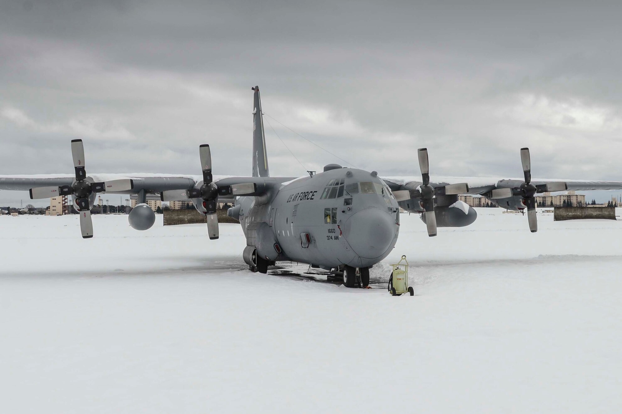 A C-130 Hercules remains covered in snow after the record-breaking snowstorm at Yokota Air Base, Japan, Feb. 15, 2014.  Total of 21 inches of snow accumulated within a 24 hour period, exceeding the maximum amount of snowfall ever recorded for the entire month of February.  (U.S. Air Force photo by Airman 1st Class Soo C. Kim / released)
