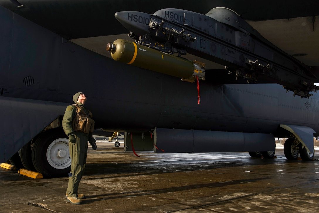 Air Force Capt. Austin Fouts conducts a pre-flight inspection of a Cluster Bomb Unit 103 on a B-52H Stratofortress aircraft on Minot Air Force Base, N.D., Feb. 11, 2014. Fouts, a pilot, is assigned to the 23rd Bomb Squadron.