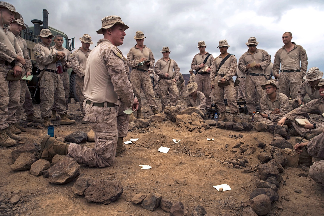 U.S. Marines receive a sand table briefing before a platoon assault exercise on Arta Range, Djibouti, Feb. 10, 2014.