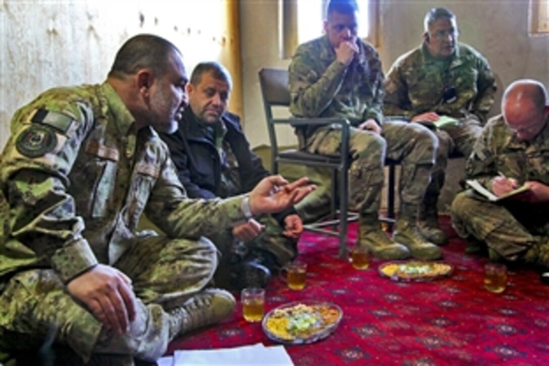 Afghan Maj. Gen. Zemerai Paikan, left, a commander of an Afghan national civil order police unit, and U.S. and Afghan army leaders discuss concerns, including security and elections, during a meeting on Forward Operating Base Sultan Kheyl in Afghanistan's Wardak province, Feb. 15, 2014.