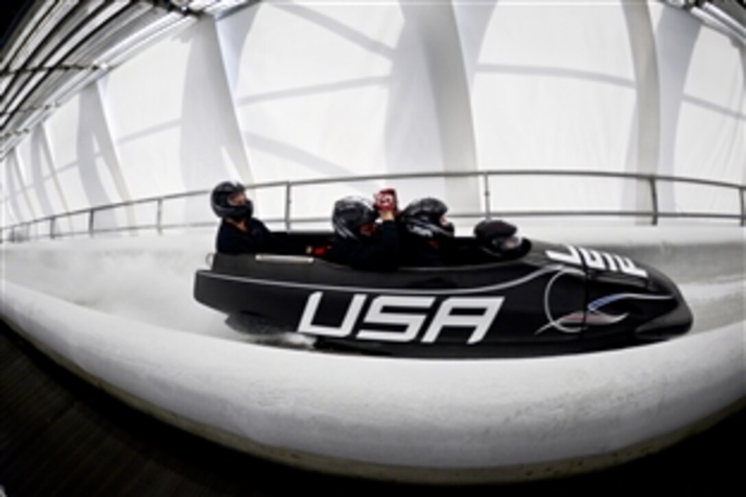 Former U.S. Army World Class Athlete Program bobsled driver Steven Holcomb makes second Olympic training run in the USA-1 four-man sled with the Army program's brakeman Capt. Chris Fogt and civilians Chris Langton and Curt Tomasevicz at Sanki Sliding Centre in Krasnaya Polyana, Russia, Feb. 19, 2014.
