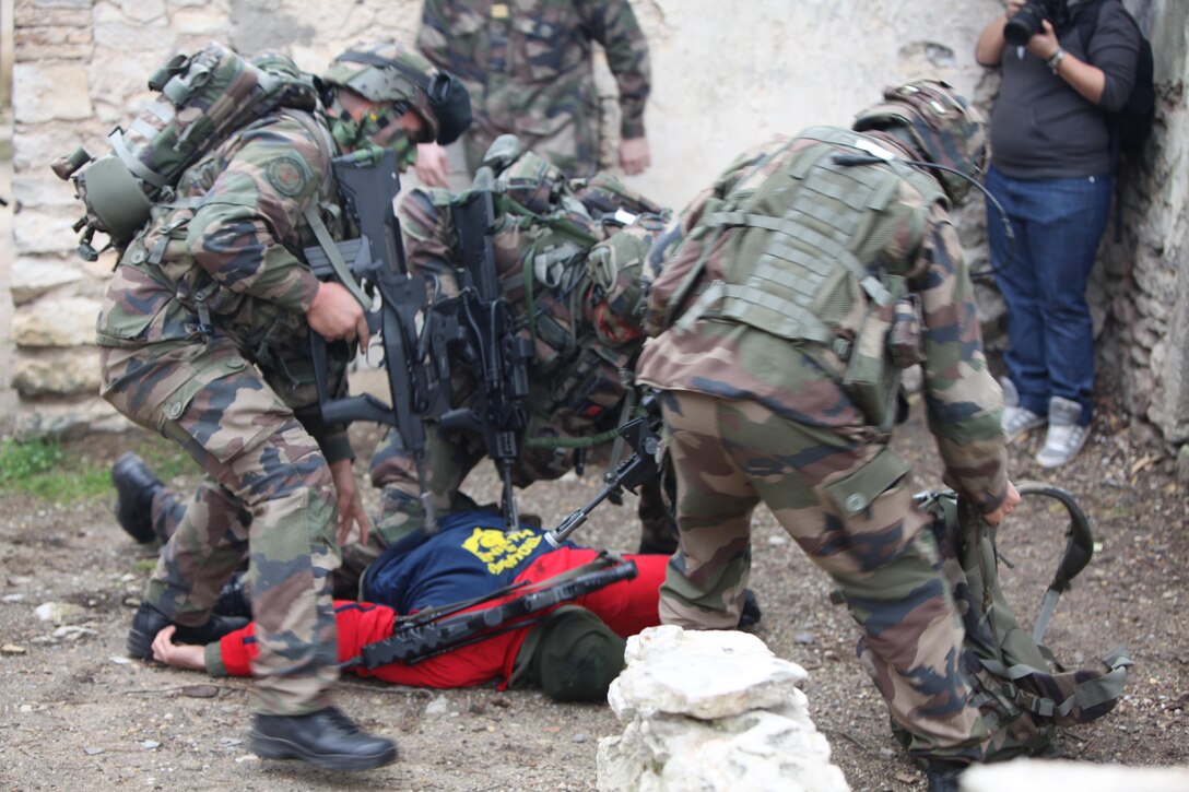 French Marines secure a simulated high-value individual during raid on a suspected enemy compound at Camp de Garrigues, outside of Nîmes, France, Feb. 13, 2014. The purpose of the week-long bilateral training was to enhance interoperability between the two allied militaries.