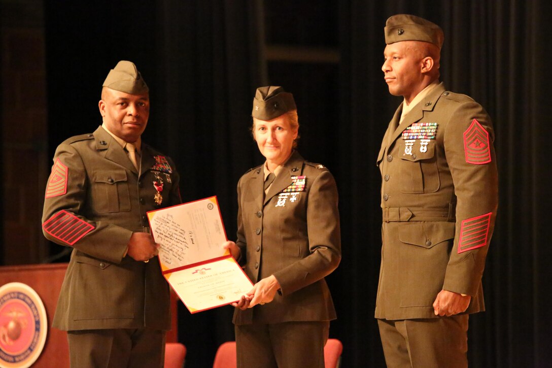 Col.  Robin Gallant, Headquarters and Service Battalion commanding officer, and Sgt. Maj. Michael Moore, former H&S Bn. sergeant major, pose for a photo during a relief and appointment ceremony at Little Hall on Feb. 19, 2014. Sgt. Maj. Gerald Saunders assumed his current duties as H&S Bn. sergeant major on Fe. 19, 2014. 