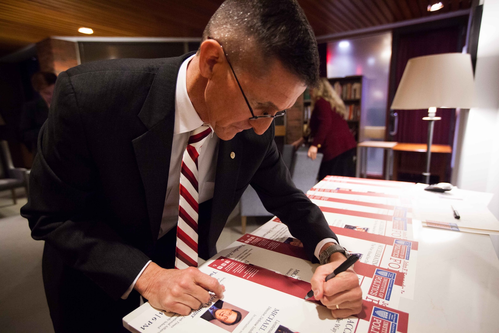 February 18th, 2014 - DIA Director Lt. Gen. Michael Flynn signs posters at Harvard Institute of Politics’ John F. Kennedy Jr. Forum. 