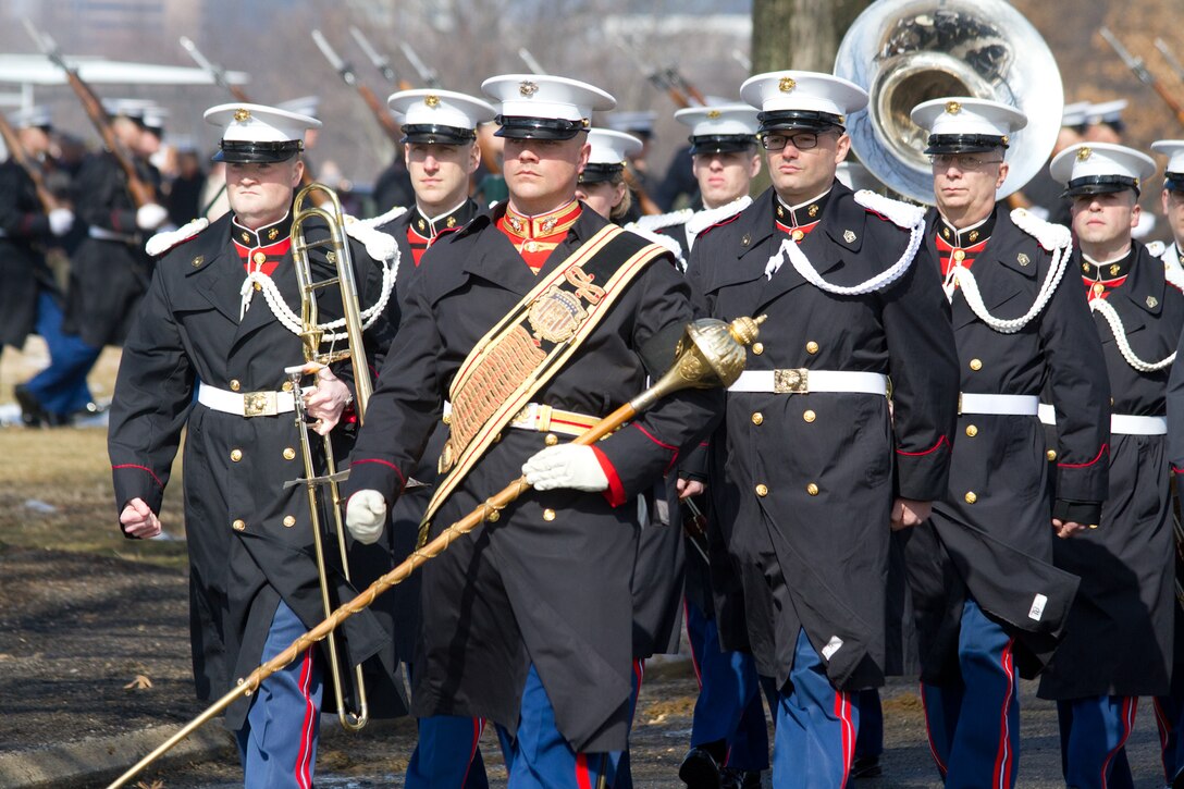 On Feb. 19, 2014, the Marine Band participated in the funeral for Colonel Charles Waterhouse, USMC (Ret.) at Arlington National Cemetery. Col. Waterhouse was the first and only artist-in-residence of the U.S. Marine Corps. On Feb. 19, 1945, Col. Waterhouse was seriously wounded during the first wave at Iwo Jima. Following the war, he graduated from Newark School of Fine and Industrial Arts. He stayed on at the school as a teacher and spent the next 28 years building a reputation as an illustrator for publications such as Outdoor Life, Reader's Digest, Rutgers Press and the Boy Scouts. Three tours of duty as a combat artist in Vietnam resulted in hundreds of on-the-spot drawings that were later turned into one large volume called Delta to DMZ. In 1973, Col. Waterhouse was brought back to active duty at the rank of major to create a series of 14 paintings of the Marines in the Revolution in celebration of the bicentennial. He retired on Feb. 19, 1991. Pictured, Assistant Drum Major Staff Sgt. Steven Williams. (U.S. Marine Corps photo by Gunnery Sgt. Amanda Simmons/released)
