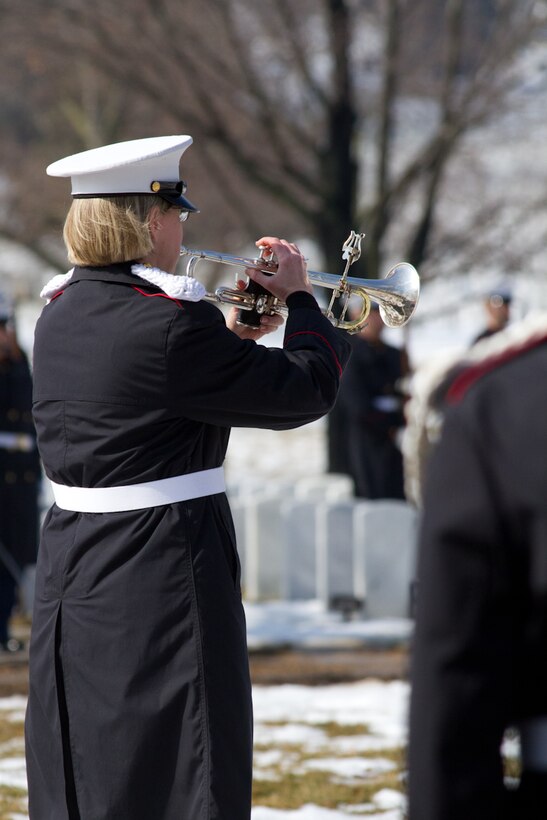 On Feb. 19, 2014, the Marine Band participated in the funeral for Colonel Charles Waterhouse, USMC (Ret.) at Arlington National Cemetery. Col. Waterhouse was the first and only artist-in-residence of the U.S. Marine Corps. On Feb. 19, 1945, Col. Waterhouse was seriously wounded during the first wave at Iwo Jima. Following the war, he graduated from Newark School of Fine and Industrial Arts. He stayed on at the school as a teacher and spent the next 28 years building a reputation as an illustrator for publications such as Outdoor Life, Reader's Digest, Rutgers Press and the Boy Scouts. Three tours of duty as a combat artist in Vietnam resulted in hundreds of on-the-spot drawings that were later turned into one large volume called Delta to DMZ. In 1973, Col. Waterhouse was brought back to active duty at the rank of major to create a series of 14 paintings of the Marines in the Revolution in celebration of the bicentennial. He retired on Feb. 19, 1991. Pictured, Master Sgt. Susan Rider sounding "Taps." (U.S. Marine Corps photo by Gunnery Sgt. Amanda Simmons/released)