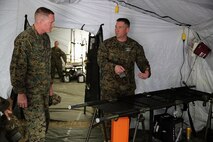 U.S. Marine Corps Brig. Gen. Edward D. Banta (left), the commanding general of 2nd Marine Logistics Group, II Marine Expeditionary Force, receives a demonstration from U.S. Navy Chief Petty Officer Gerald C. Auvil (right), an independent duty corpsman serving as the senior enlisted leader for Alpha Surgical Company, 2nd Medical Battalion, 2nd Marine Logistics Group, at Landing Zone Canary during a field exercise aboard Camp Lejeune, N.C., Feb. 19, 2014. Sailors with the battalion simulated patients going through the Shock Trauma Platoon and a Forward Resuscitative Surgical System. 