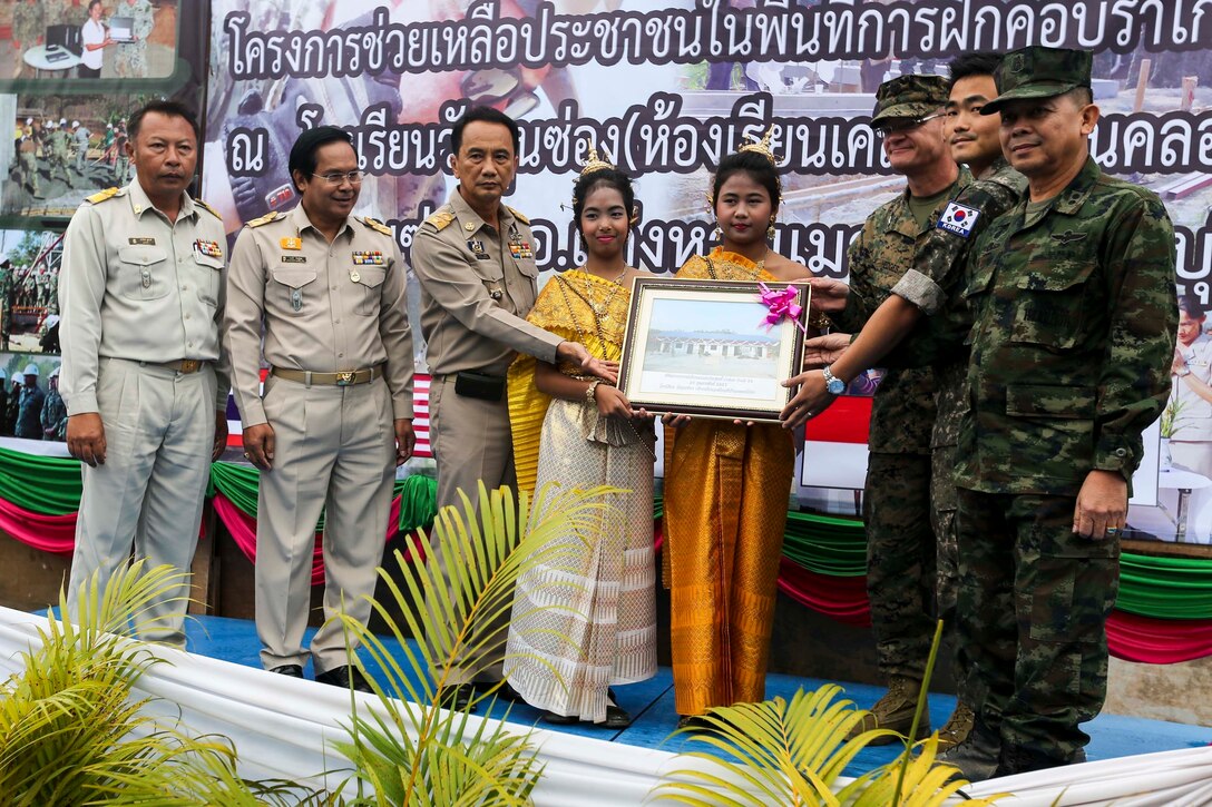Senior Thai, U.S. and Republic of Korea representatives are presented a plaque of appreciation at the Wat Kun Song school dedication ceremony during Exercise Cobra Gold in Chanthaburi Province, Kingdom of Thailand, Feb. 20. Cobra Gold, in its 33rd iteration, demonstrates the U.S. and the Kingdom of Thailand's commitment to our long-standing alliance and regional partnership, prosperity and security in the Asia-Pacific region. The building of the school is a combined effort between the Kingdom of Thailand, U.S., and Republic of Korea.