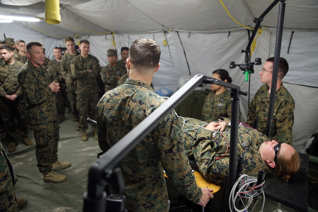 U.S. Navy Chief Petty Officer Gerald C. Auvil (left), an independent duty corpsman serving as the senior enlisted leader for Alpha Surgical Company, 2nd Medical Battalion, 2nd Marine Logistics Group, demonstrates health care procedures in a walk-through during a field exercise at Landing Zone Canary aboard Camp Lejeune, N.C., Feb. 19, 2014. Sailors with deployed experience gave many classes and walked through step-by-step the procedure in which a patient flows through the medical treatment whether it’s in Shock Trauma Platoon or a Forward Resuscitative Surgical System.