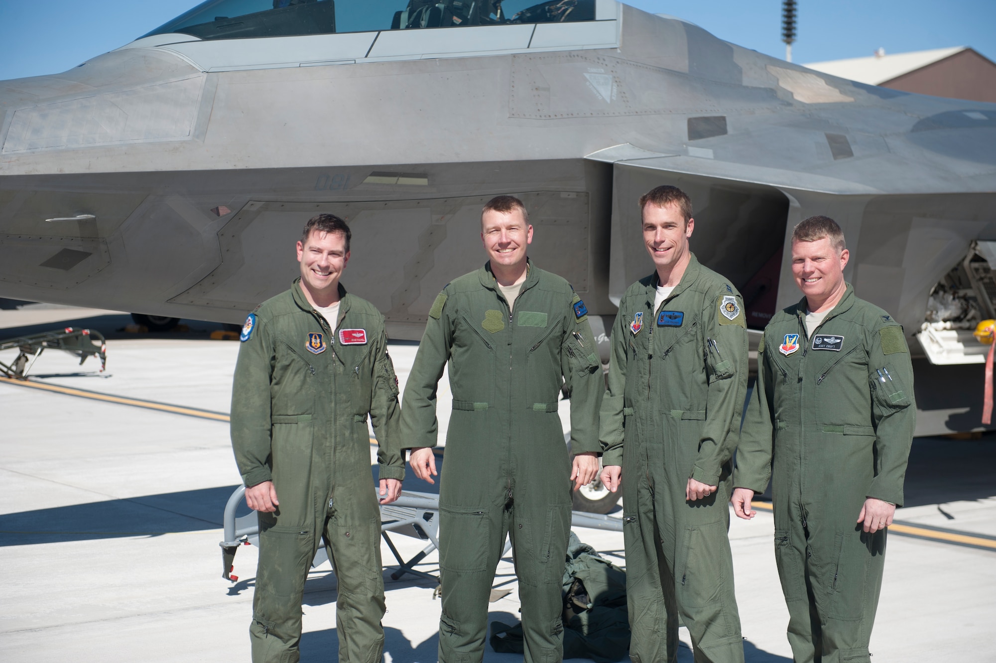 Major Jesse Colwell, F-22 Raptor pilot, Lt. Col. Shawn Anger, 7th Fighter Squadron commander, Capt. John Fischer, F-22 Raptor pilot, and Col. Andrew Croft, 49th Wing commander, stand in front of an F-22 at Holloman Air Force Base, N.M., Feb. 20. The 7th Fighter Squadron and members of the Holloman community celebrated this sortie before the F-22s depart for Tyndall Air Force Base, Fla., in early April. (U.S. Air Force photo by Airman 1st Class Daniel Liddicoet/Released)