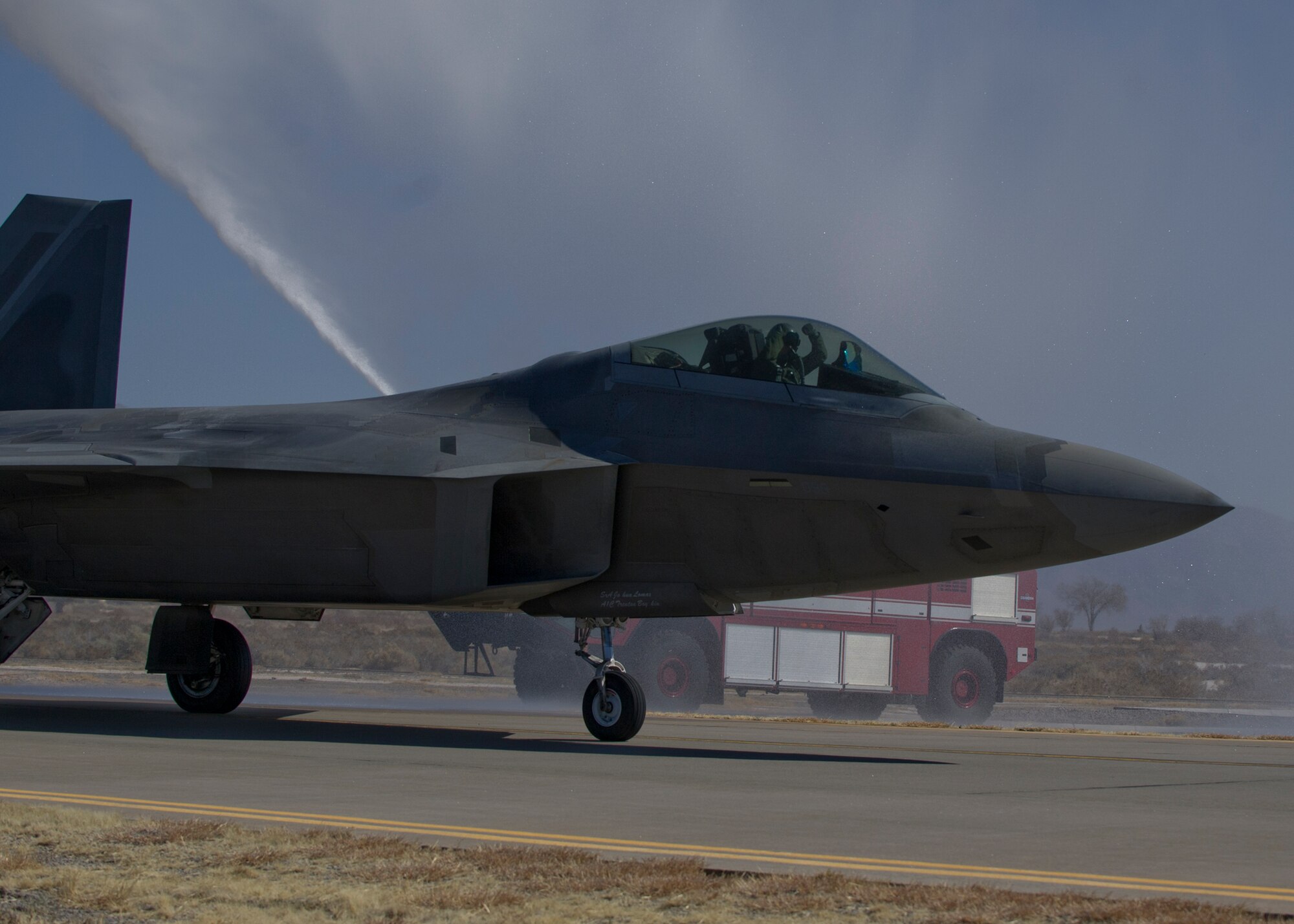An F-22 Raptor pilot celebrates at Holloman Air Force Base N.M., after completing the final four-ship tactical sortie over the Tularosa Basin Feb. 20. The 7th Fighter Squadron and members of the Holloman community celebrated this final sortie before the F-22s depart for Tyndall Air Force Base, Fla., in early April. (U.S. Air Force photo by Airman 1st Class Chase Cannon/Released)