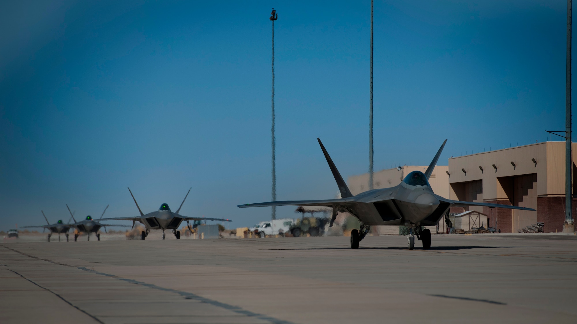 Four F-22 Raptors return from the final four-ship tactical sortie flown at Holloman Air Force Base, N.M., Feb. 20. The 7th Fighter Squadron and members of the Holloman community celebrated this sortie before the F-22s depart for Tyndall Air Force Base, Fla., in early April. (U.S. Air Force photo by Airman 1st Class Aaron Montoya / Released)