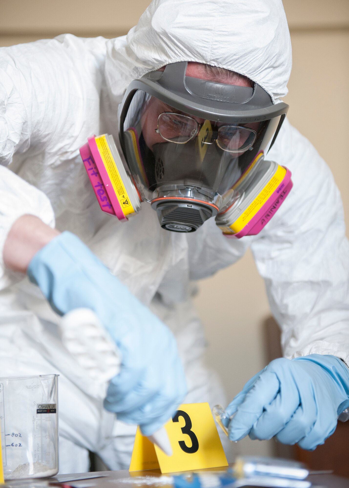 Capt. Andrew Bostic, 374th Aerospace Medicine Squadron chief of operation for bioenviromental engineering, takes a sample of a simulated unknown substance during a hazardous material training exercise at Yokota Air Base, Japan, Feb. 20, 2014. The primary purpose of the exercise was joint crime scene preservation training among emergency management, bioenvironmental engineers, fire department, security forces, medical technicians and Air Force Office of Special Investigations to ensure minimal scene disturbance while completing presumptive identification, sampling and evidence collection.(Japan Air Self Defense Force photo by Tech. Sgt. Fumiaki Nishihara/released)