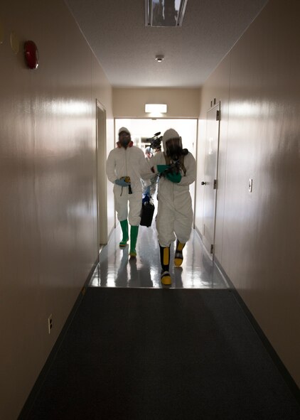 (Right to left) Senior Airman Luke Luallin, 374th Civil Engineer Squadron emergency management technician, and Capt. Andrew Bostic, 374th Aerospace Medicine Squadron chief of operation for bioenviromental engineering, respond to a collection of simulated unknown substances during an emergency management exercise at Yokota Air Base, Japan, Feb. 20, 2014. The primary purpose of the exercise was a joint crime scene preservation training among emergency management, bioenvironmental engineers, fire department, security forces, medical technicians and Air Force Office of Special Investigations to ensure minimal scene disturbance while completing presumptive identification, sampling and evidence collection.(Japan Air Self Defense Force photo by Tech. Sgt. Fumiaki Nishihara/released)