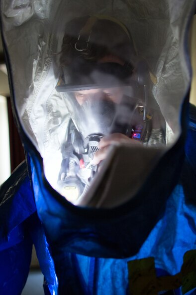 Staff Sgt. Wesley Barlow, 374th Aerospace Medicine Squadron bioenvironmental engineering technician, records a simulated unknown substance during a hazardous material training exercise at Yokota Air Base, Japan, Feb. 20, 2014. The primary purpose of the exercise was joint crime scene preservation training among emergency management, bioenvironmental engineers, fire department, security forces, medical technicians, and Air Force Office of Special Investigations to ensure minimal scene disturbance while completing presumptive identification, sampling and evidence collection. (U.S. Air Force photo by Osakabe Yasuo/Released)
