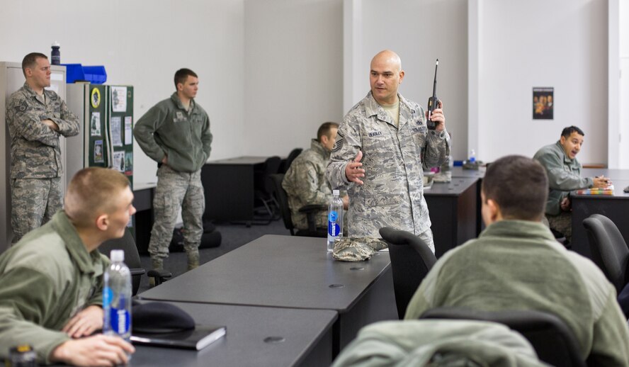 Master Sgt. James Beasley, center, 374th Civil Engineer Squadron, talks to patrolmen from the 374th Security Forces Squadron during a hazardous material training exercise at Yokota Air Base, Japan, Feb. 20, 2014. The primary purpose of the exercise was joint crime scene preservation training among emergency management, bioenvironmental engineers, fire department, security forces, medical technicians, and Air Force Office of Special Investigations to ensure minimal scene disturbance while completing presumptive identification, sampling and evidence collection. (U.S. Air Force photo by Osakabe Yasuo/Released)