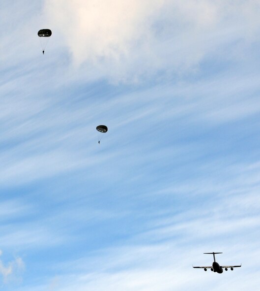 Airmen from the 22nd Special Tactics Squadron perform a static line jump from a C-17 Globemaster III at 1,000 feet above McChord Field, Feb. 12, 2014 at Joint Base Lewis-McChord, Wash. Static line jumps are used for immediate insertion into enemy territory and the 22nd STS Airmen practice them monthly. (U.S. Air Force photo/Staff Sgt. Russ Jackson)