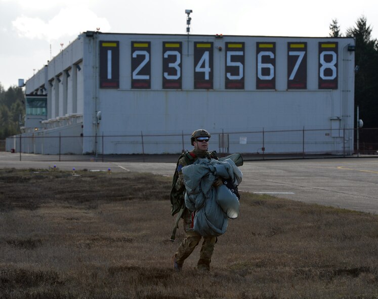 After his high altitude, low opening jump, Airman 1st Class Nico Rodriguez, 22nd Special Tactics Squadron combat controller prepares to turn in his parachute to riggers at McChord Field, Feb. 12, 2014 at Joint Base Lewis-McChord, Wash. Once each parachute is accounted for, the riggers take custody of the parachutes and prepare them for the next jump. (U.S. Air Force photo/Staff Sgt. Russ Jackson)