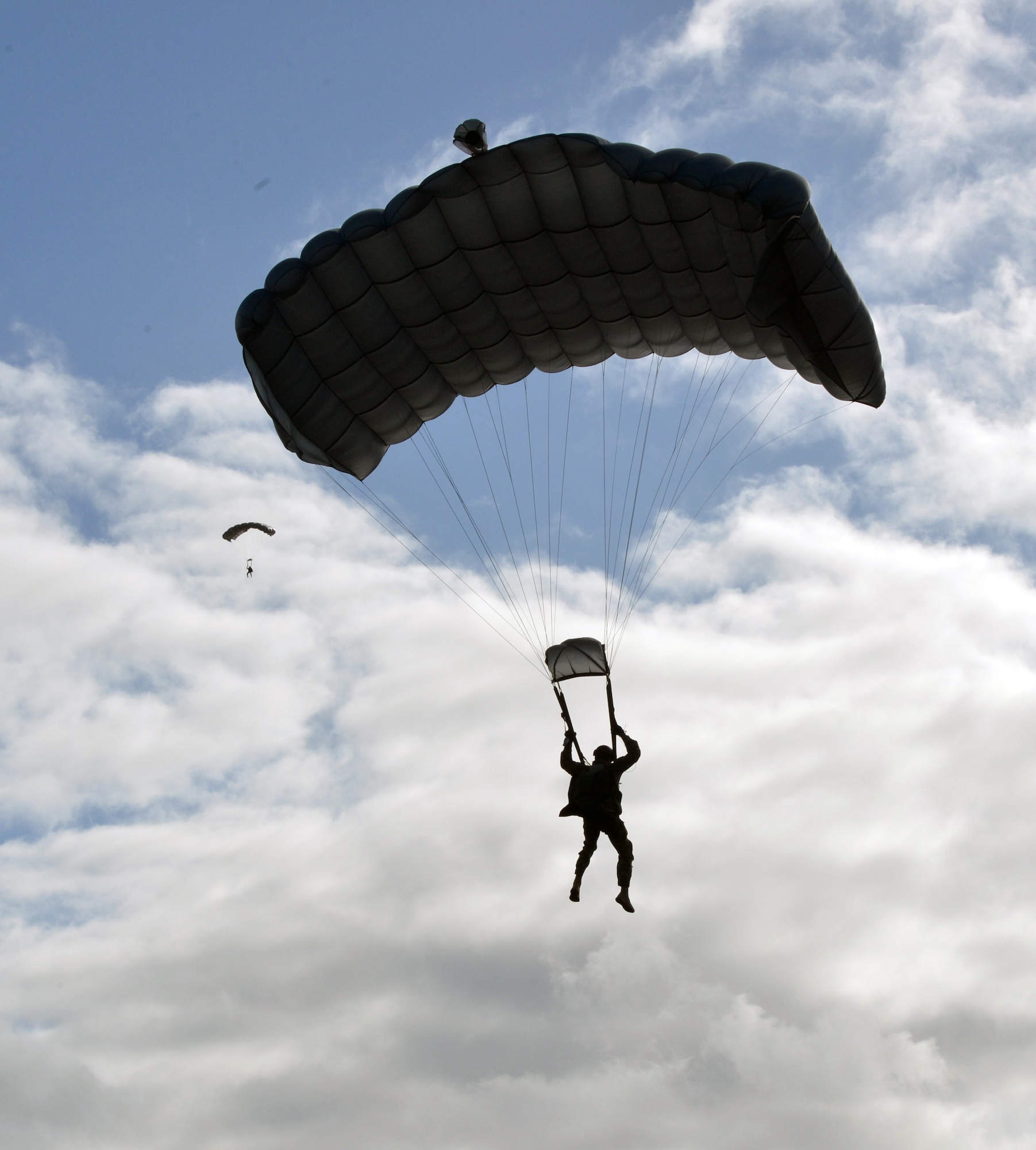 Two 22nd Special Tactics Squadron Airmen perform a high altitude, low opening parachute jump, Feb. 12, 2014 at Joint Base Lewis-McChord, Wash. The airmen practice landing as close to their designated landing zone as possible. (U.S. Air Force photo/Staff Sgt. Russ Jackson)