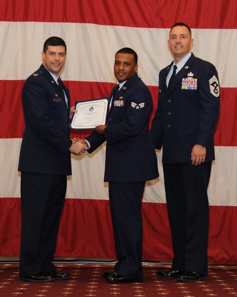 Senior Airman Hubert Staten, 307th Civil Engineer Squadron, receives an Airman Leadership School graduation certificate from Col. Andrew Gebara, 2nd Bomb Wing commander, on Barksdale Air Force Base, La., Feb. 13, 2014. (U.S. Air Force photo/Senior Airman Joseph A. Pagán Jr.)